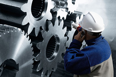 Worker Inspecting Large Gears